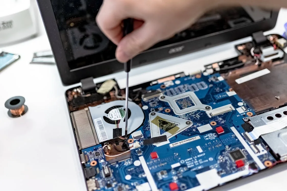 Technician repairing a laptop motherboard at RAM Infotech laptop service center in Chennai